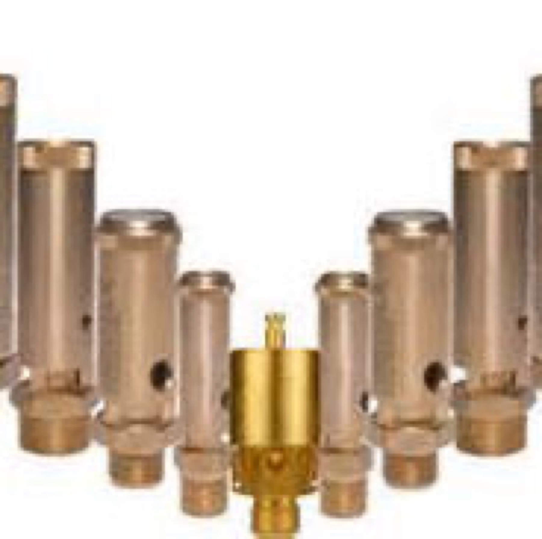 Brass dental fittings arranged on a white surface